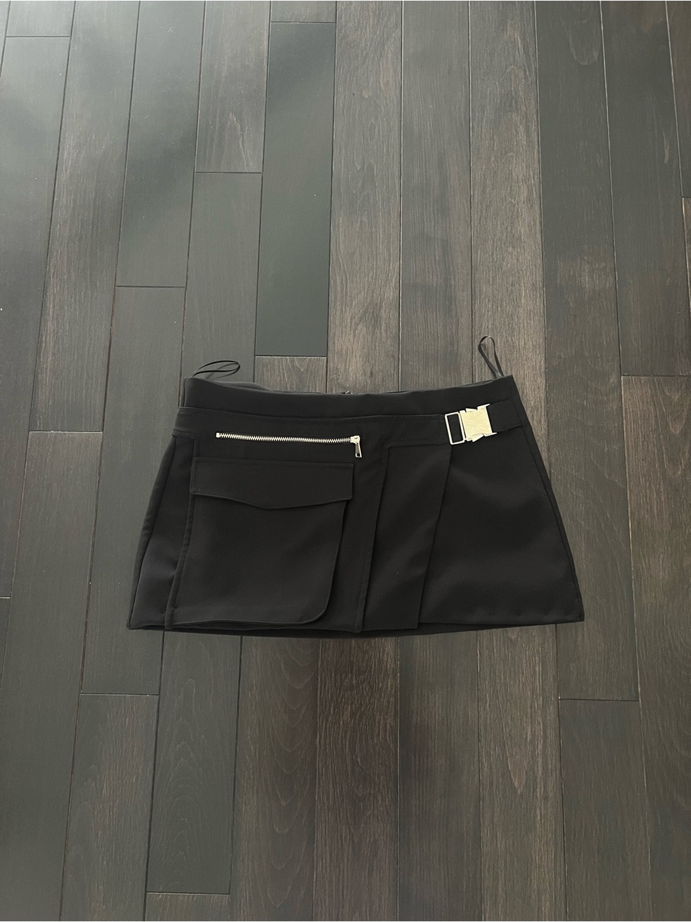 Low rise black mini skirt with silver buckle detail